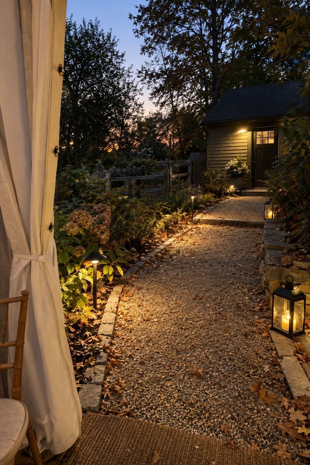 Warm pathway lights marking a safe gravel route from an October wedding tent at dusk