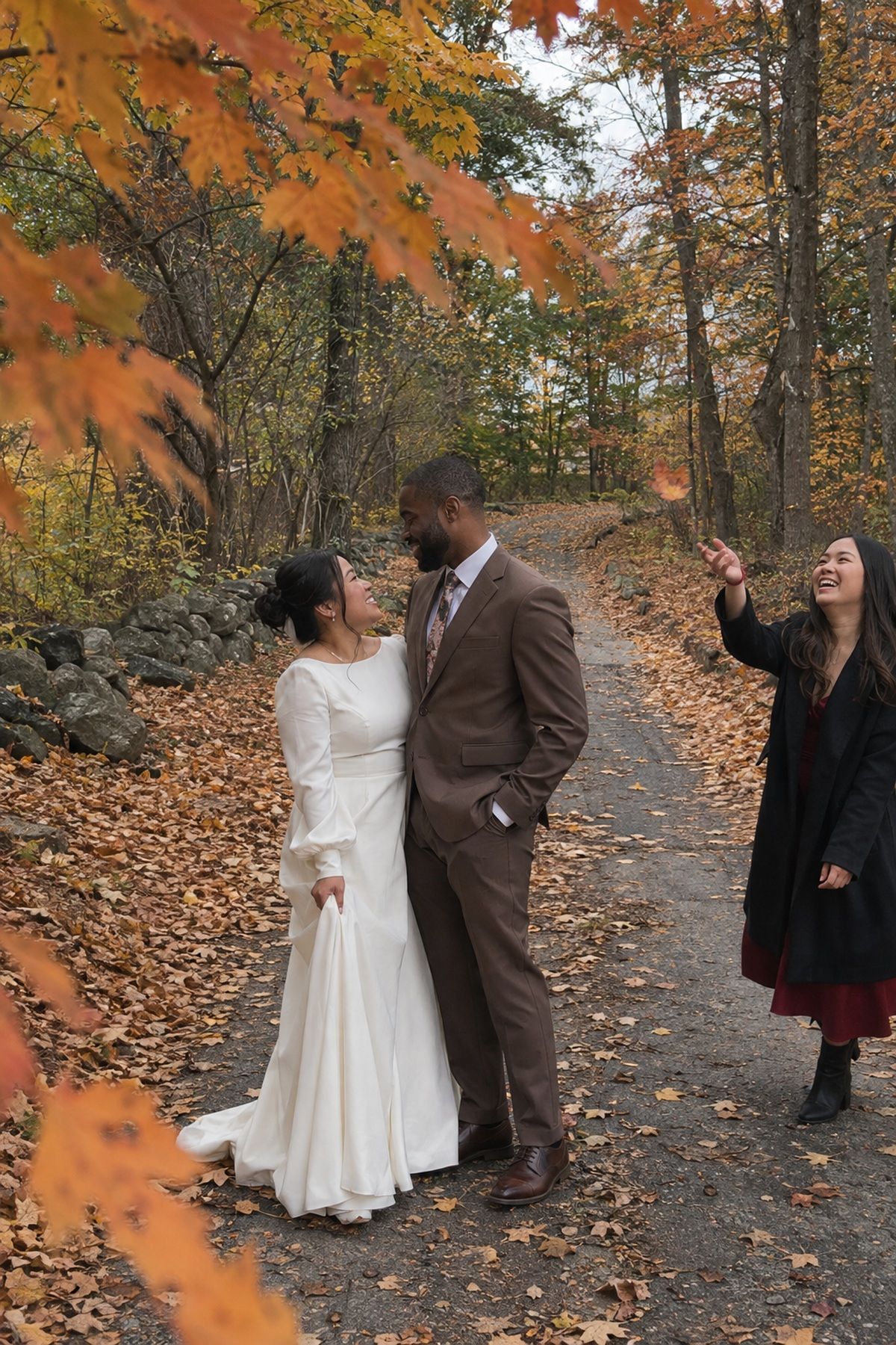 A newlywed couple pauses for foliage-framed October wedding portraits.