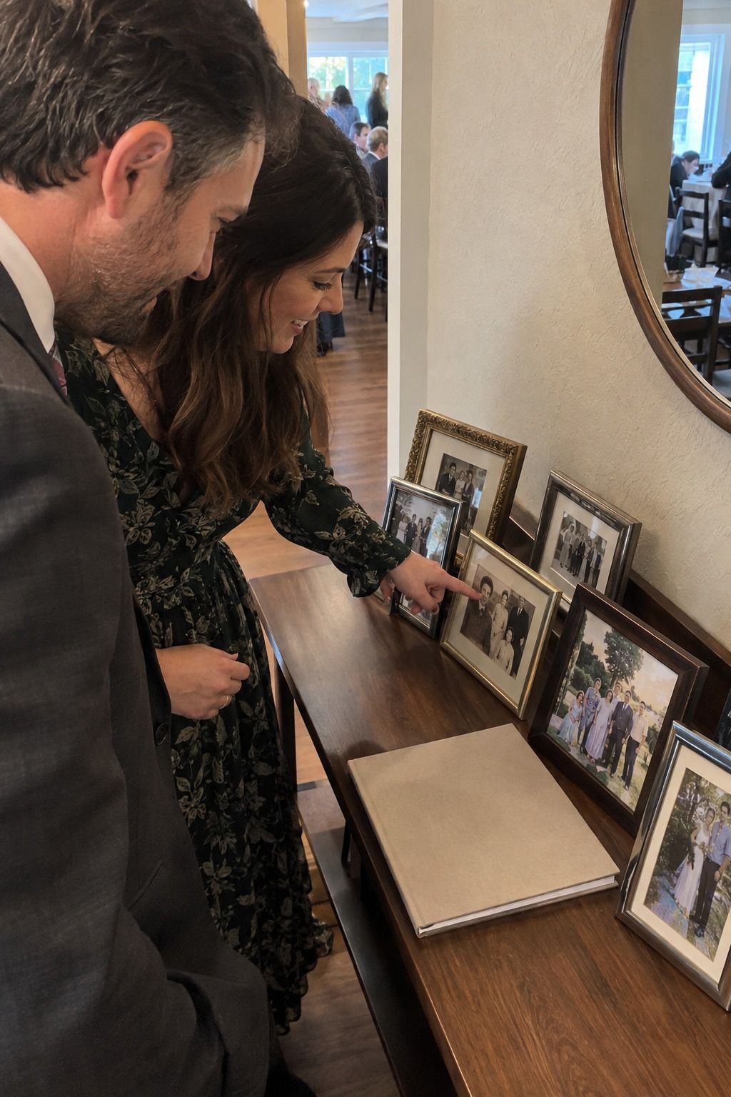 Guests pause together at a personal family photo and memory table.