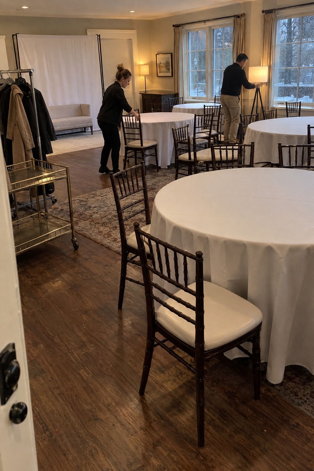 A coordinator and venue worker complete an intentional indoor backup while rain falls outside.
