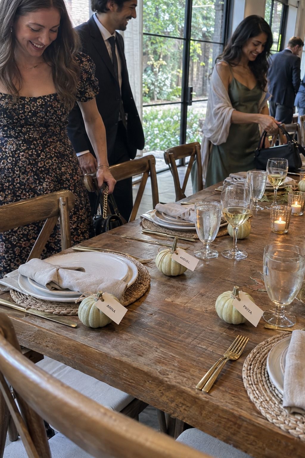 Guests take seats beside one tiny pale pumpkin and one correctly named tag per setting.