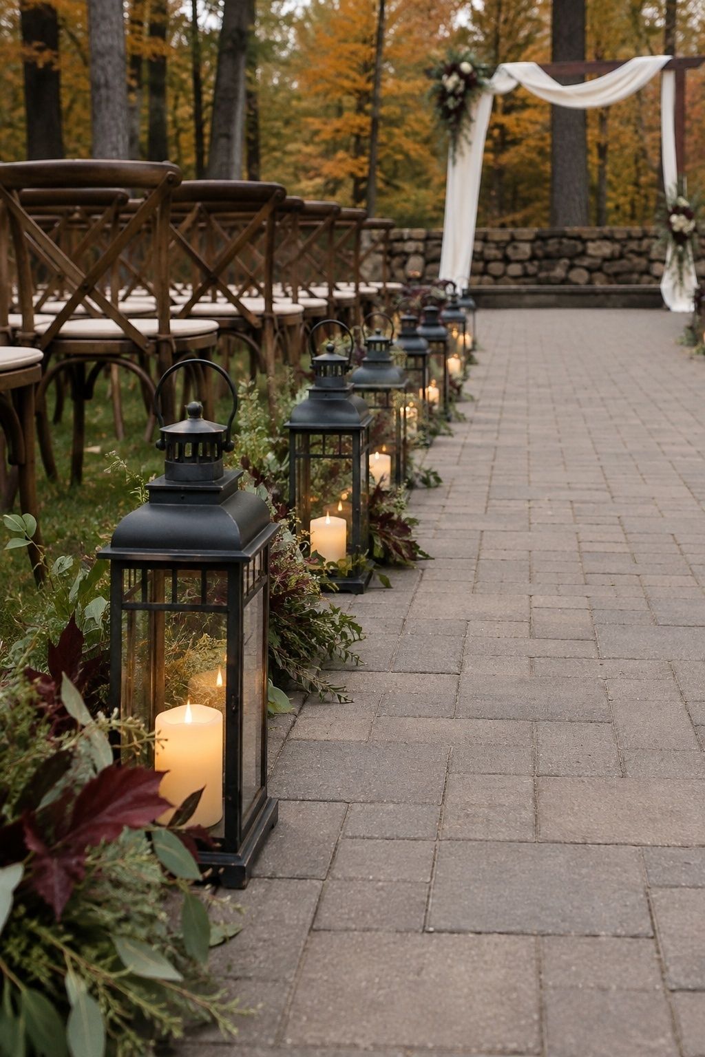 Outdoor fall wedding aisle lined with low lanterns