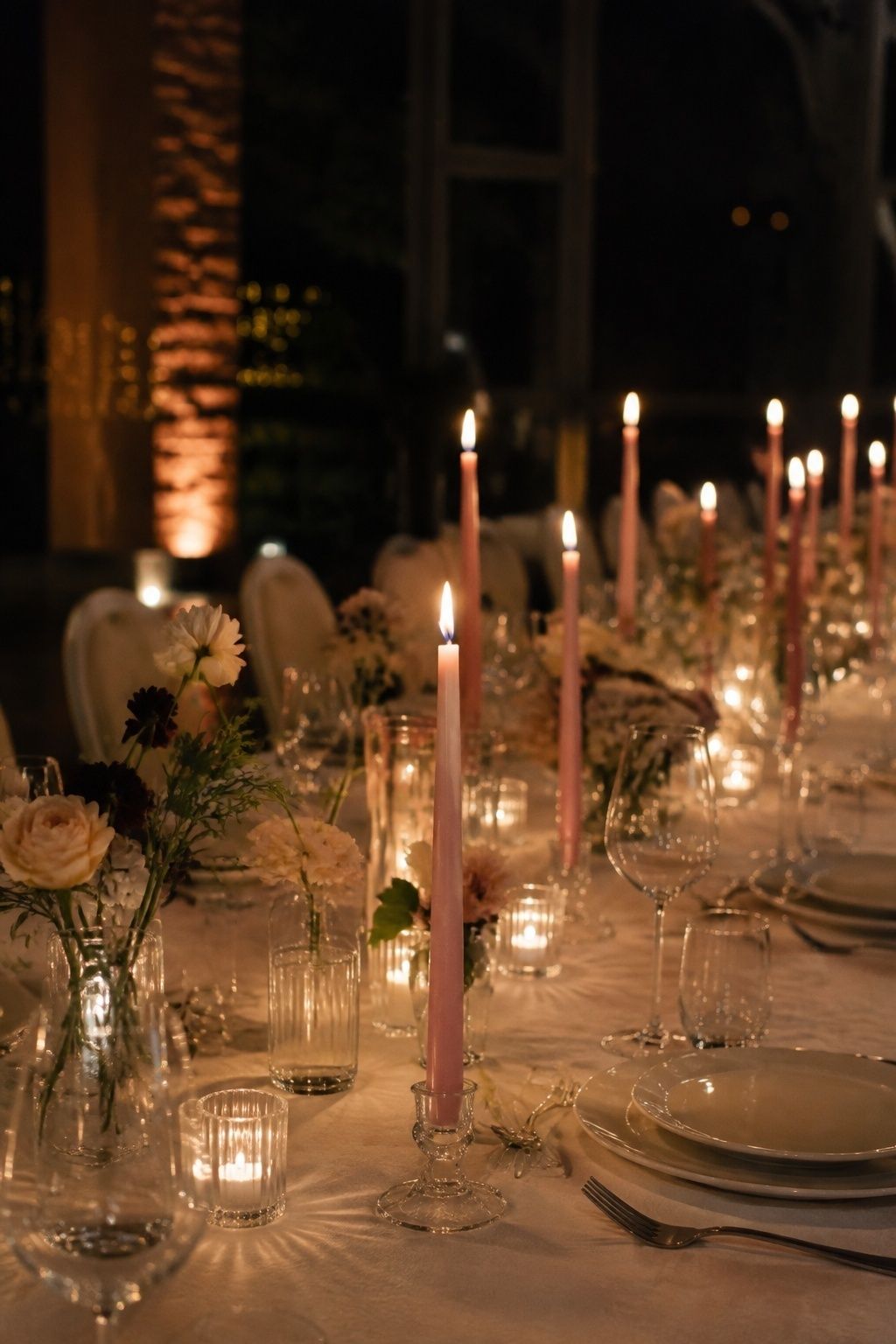 Soft pink taper candles in clear glass holders
