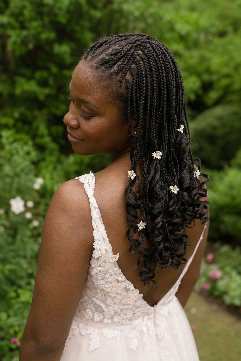 Bride wearing floral french curl braids.