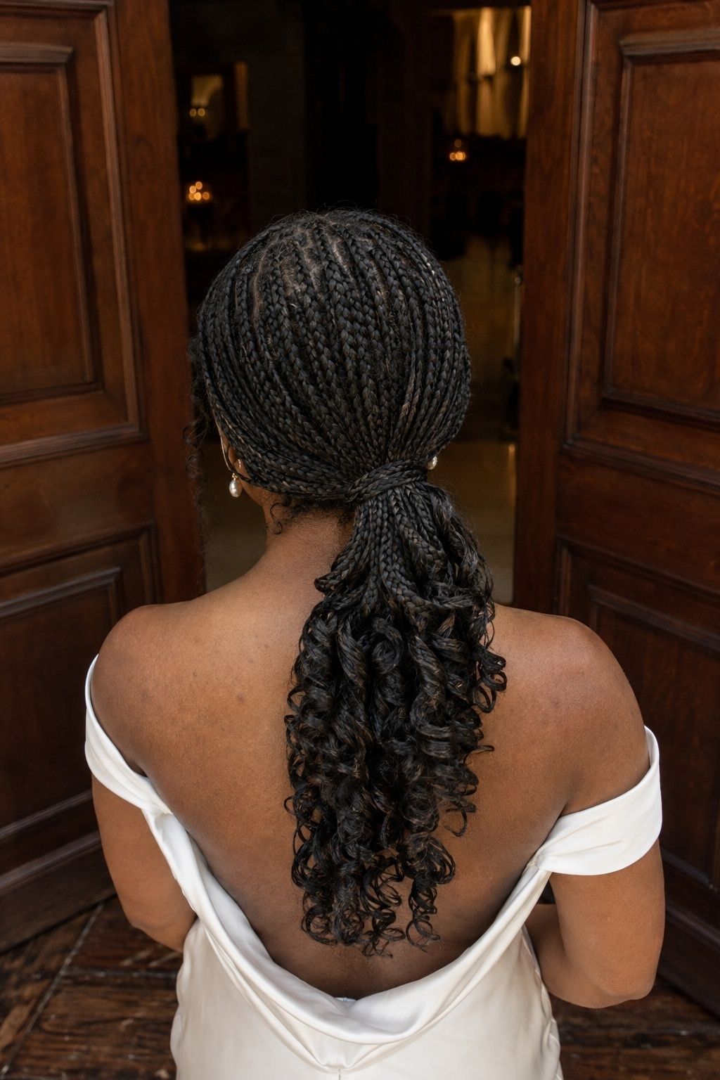Bride wearing low ponytail pick and drop french curls.