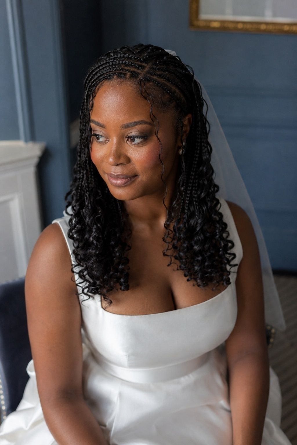 Bride wearing french curl braids with a clean middle length.