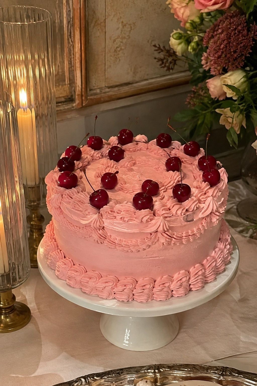 Cherry-topped pink and red vintage cake