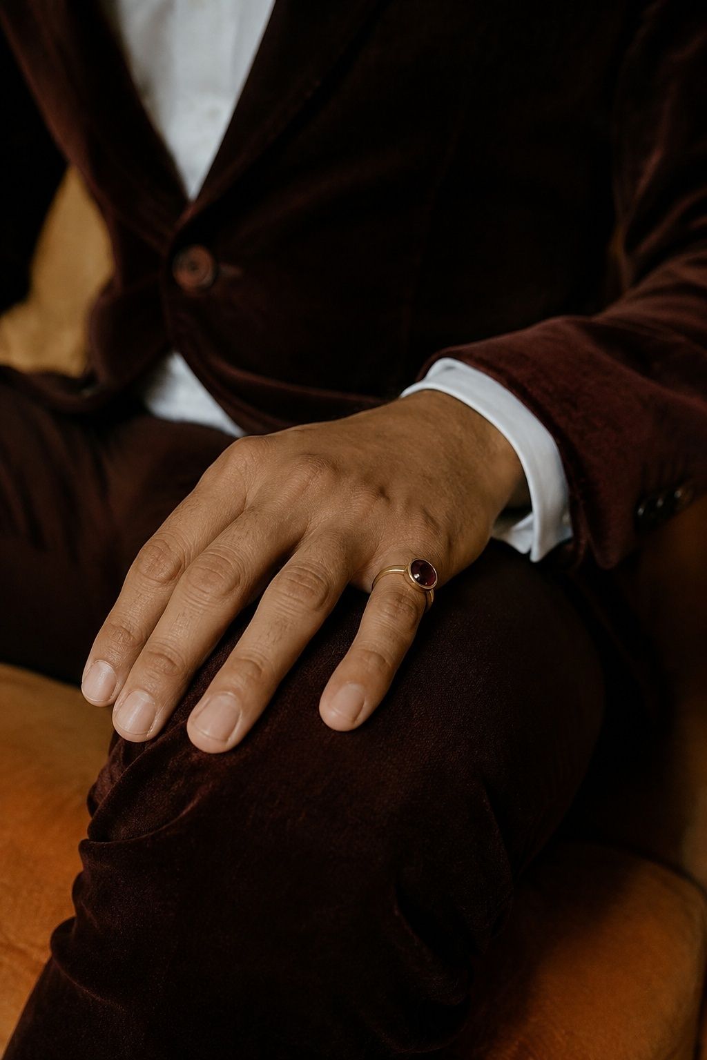Groom in a velvet jacket wearing a stone-set pinky ring