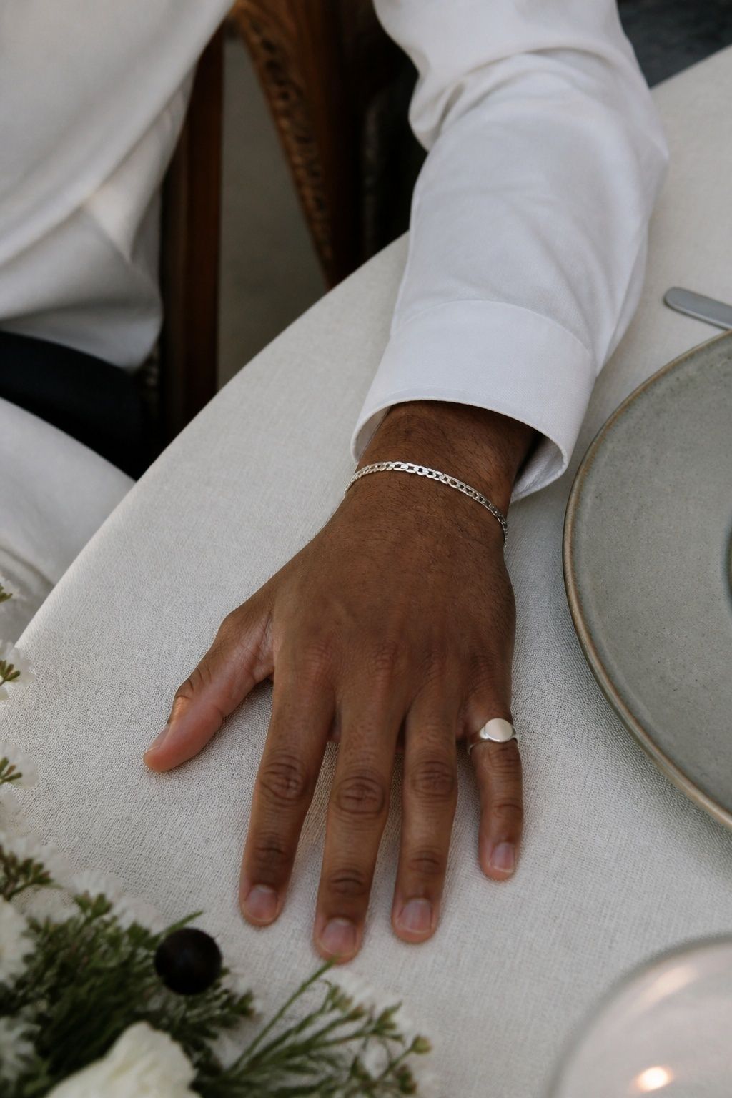 Groom's pinky ring styled with a narrow bracelet