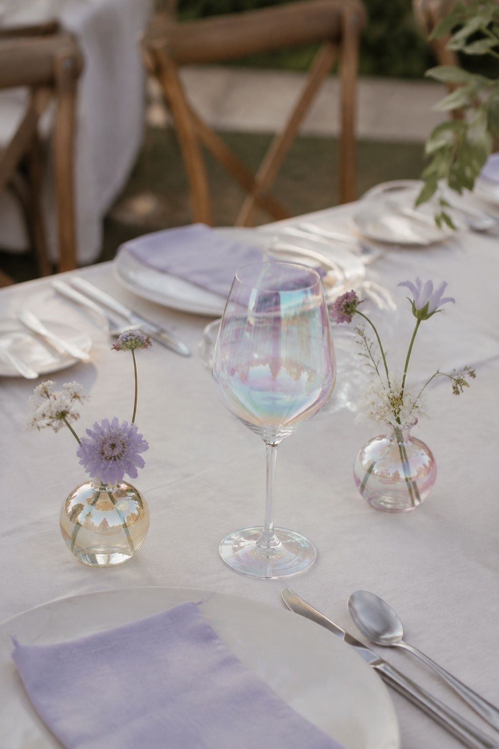 Iridescent glassware on a calm ivory and lavender guest table