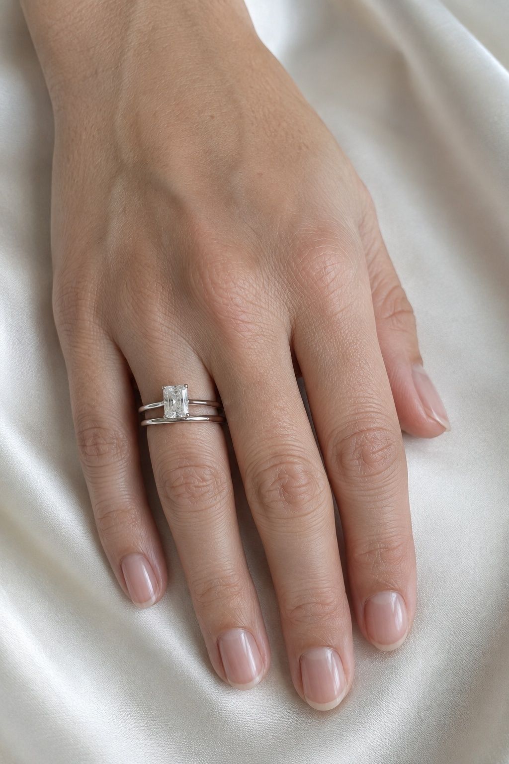 Straight wedding band sitting flush with a radiant ring
