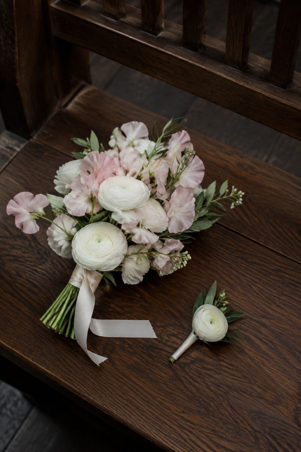 Compact white and blush bouquet with a matching small ranunculus boutonniere