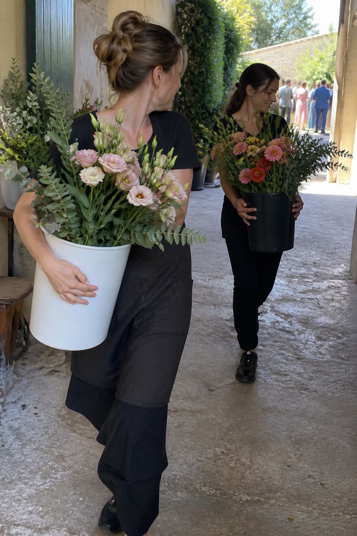 Florists carry summer flowers upright in clean water buckets to keep them hydrated.