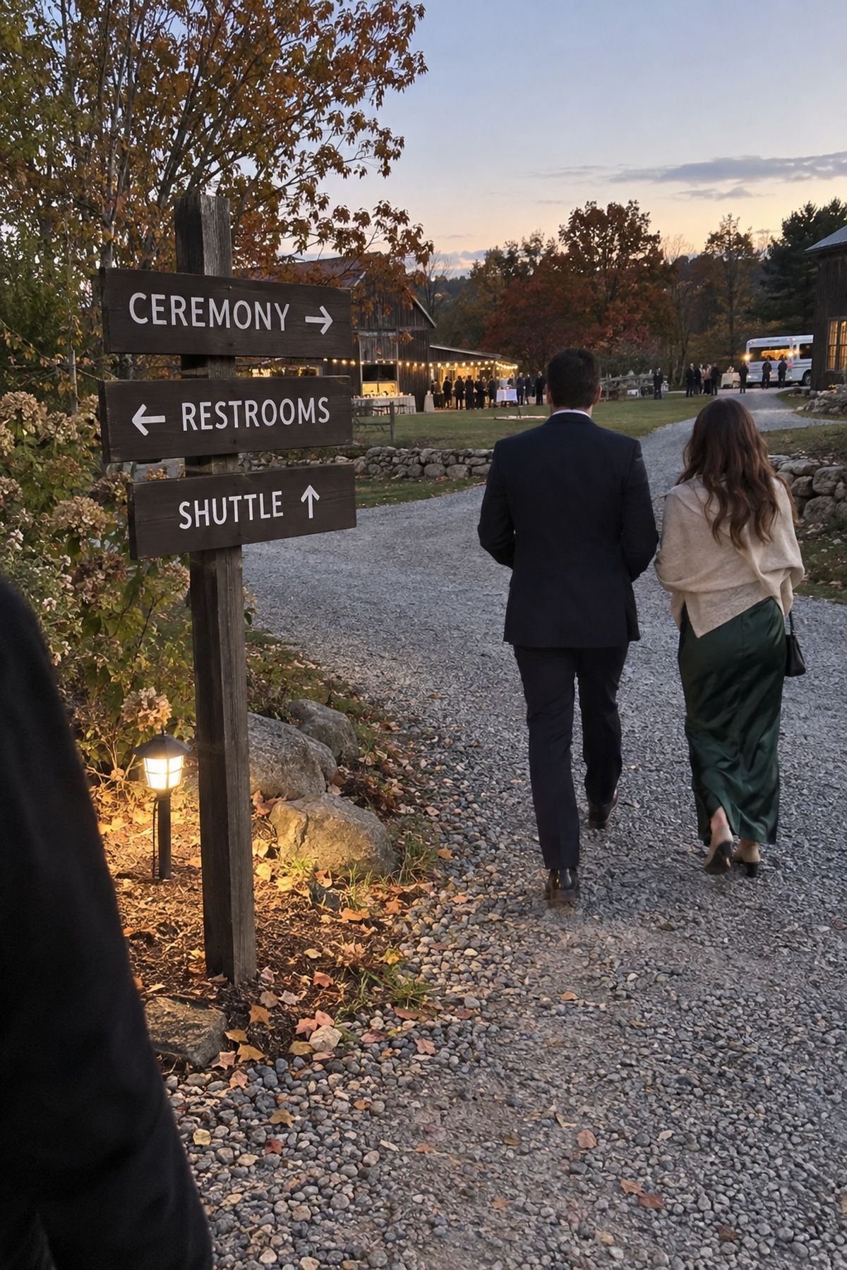 Short readable signs direct guests toward the ceremony, restrooms, and shuttle.