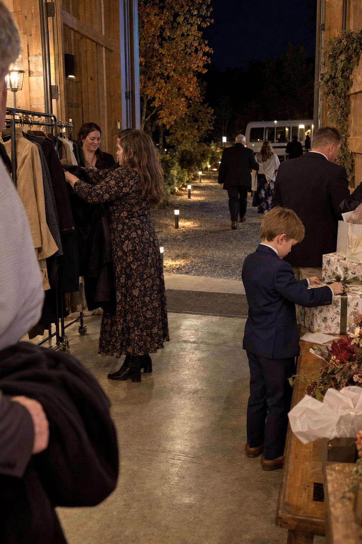 Guests collect coats and gifts before following a lit route to the wedding shuttle.