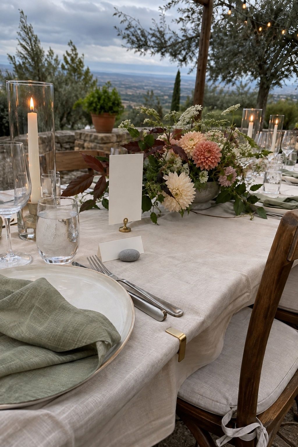 Wind-safe outdoor wedding table with clipped paper, weighted card and enclosed candles