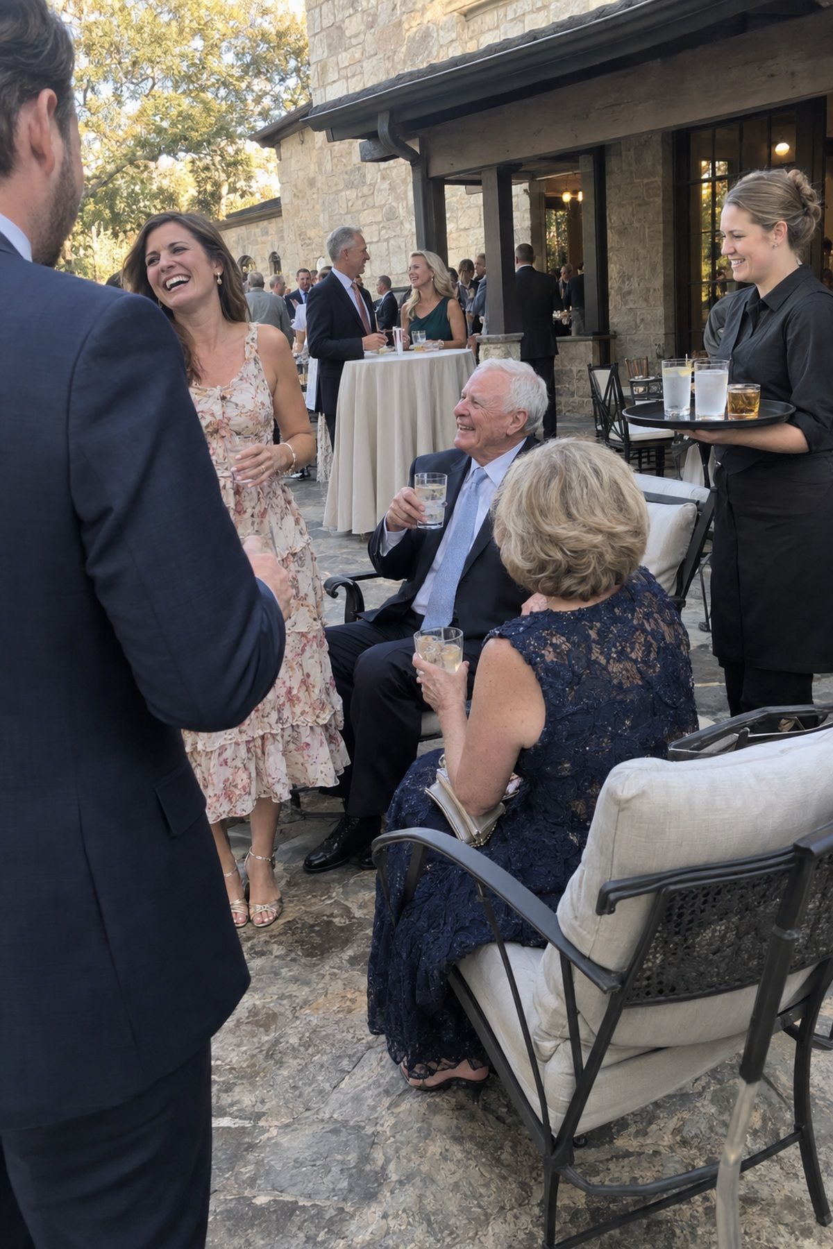 Guests mingle beside comfortable seating during an outdoor September cocktail hour.