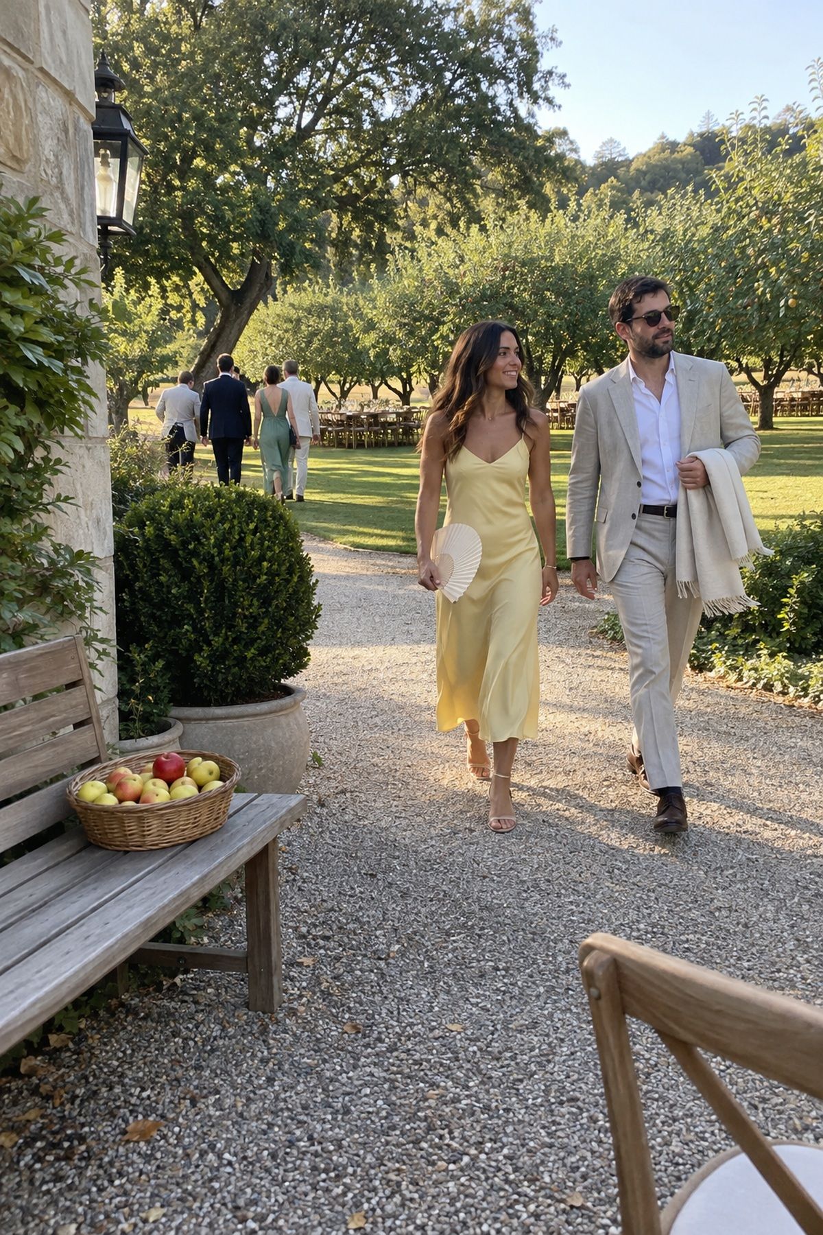 Guests transition from a September garden ceremony toward an orchard dinner setting.