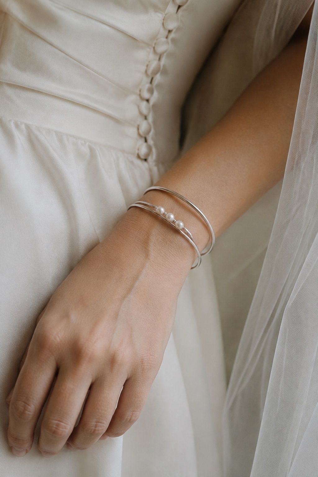 Silver bangle stack with pearl accents