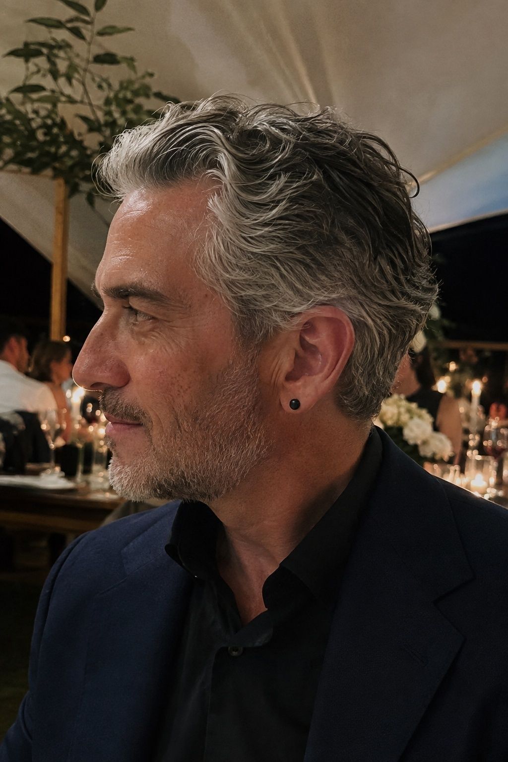 Black-and-silver stud earrings with a midnight suit