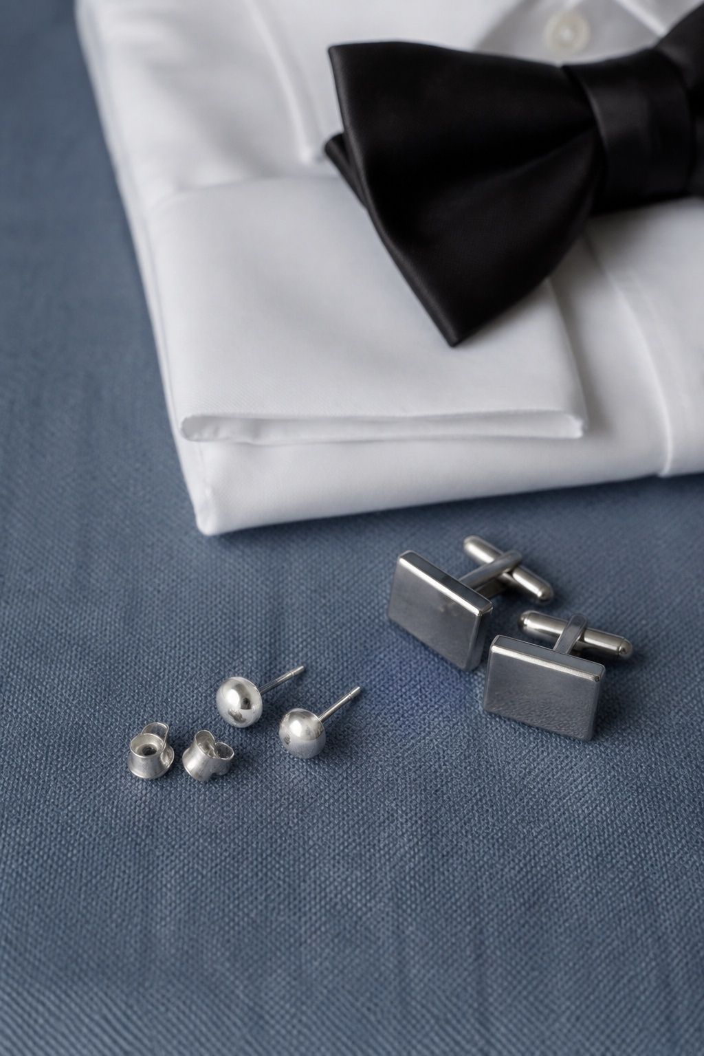 Silver earrings matched with cufflinks