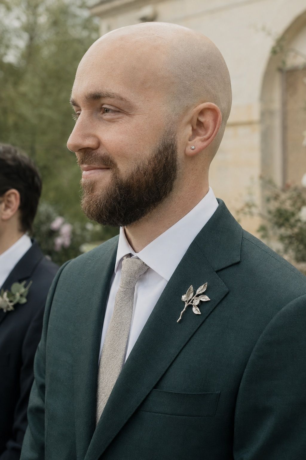 Silver earrings worn with a groom brooch