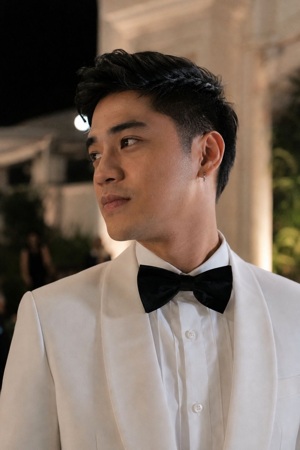 White dinner jacket paired with silver earrings
