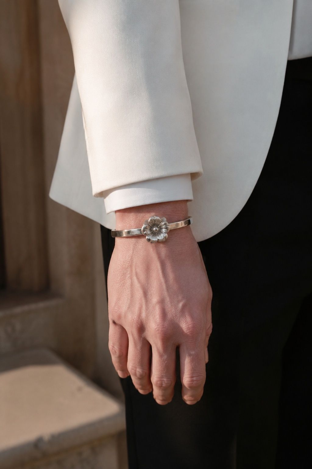 Sculptural flower bracelet with a white dinner jacket