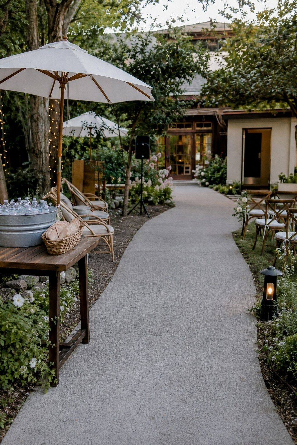 Accessible shaded garden wedding arrival with water, fans, chairs, and parasols