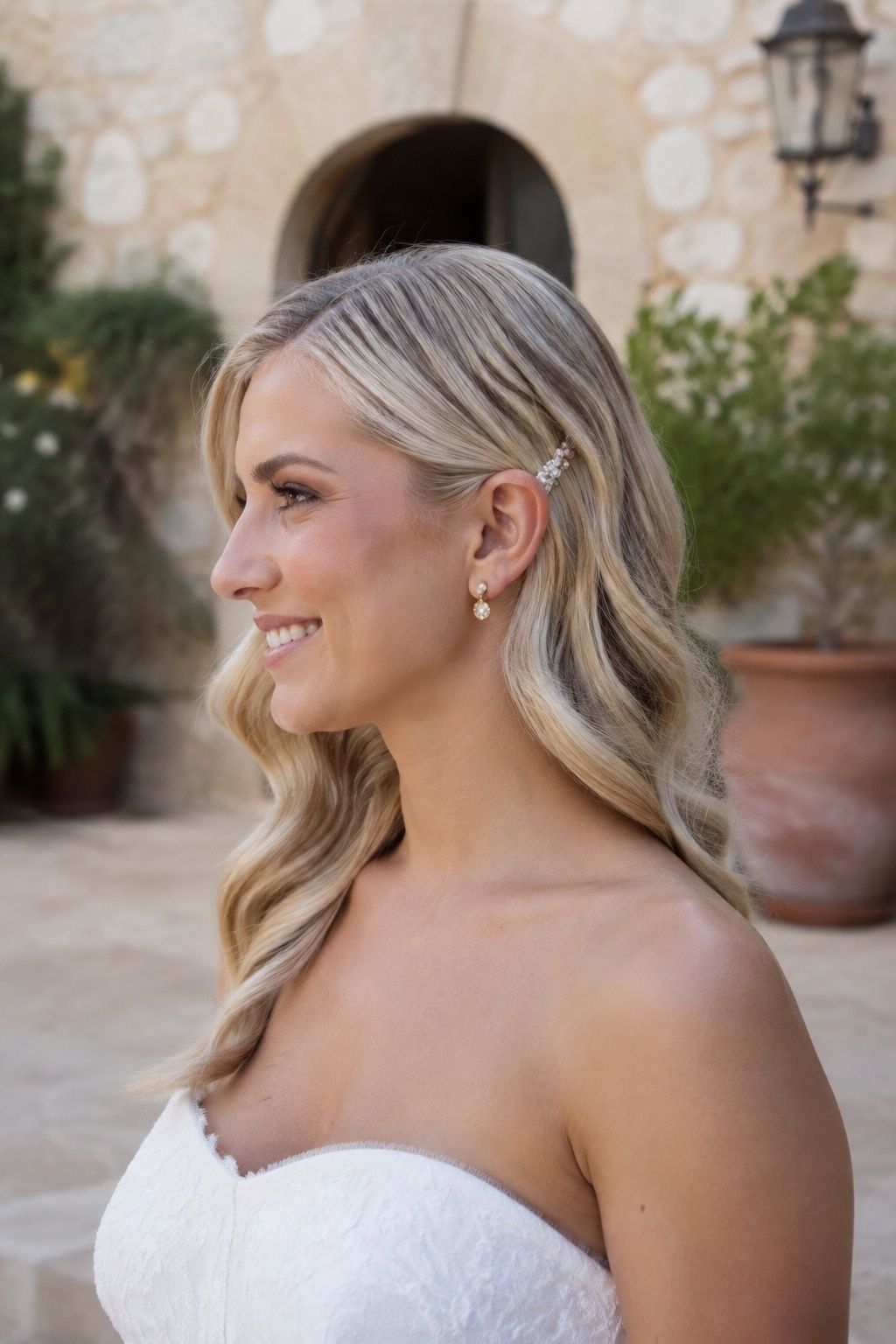 Side part wedding waves with one ear tucked