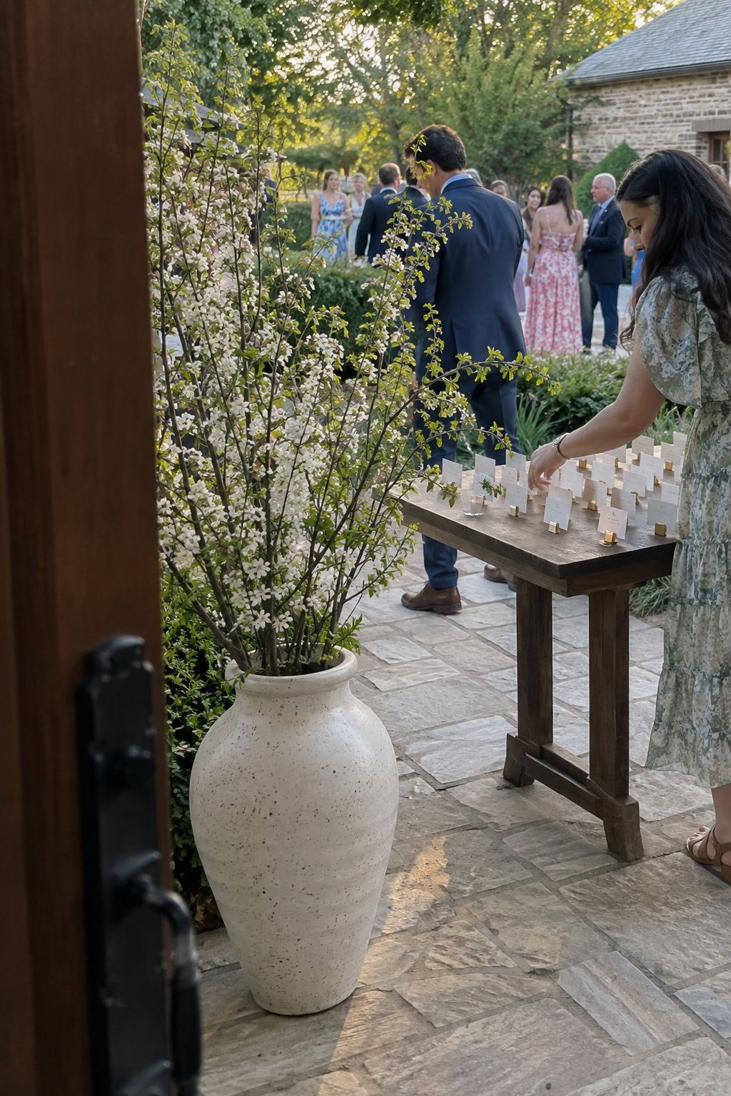 Flowering branch arrangement with generous clearance beside a garden escort table