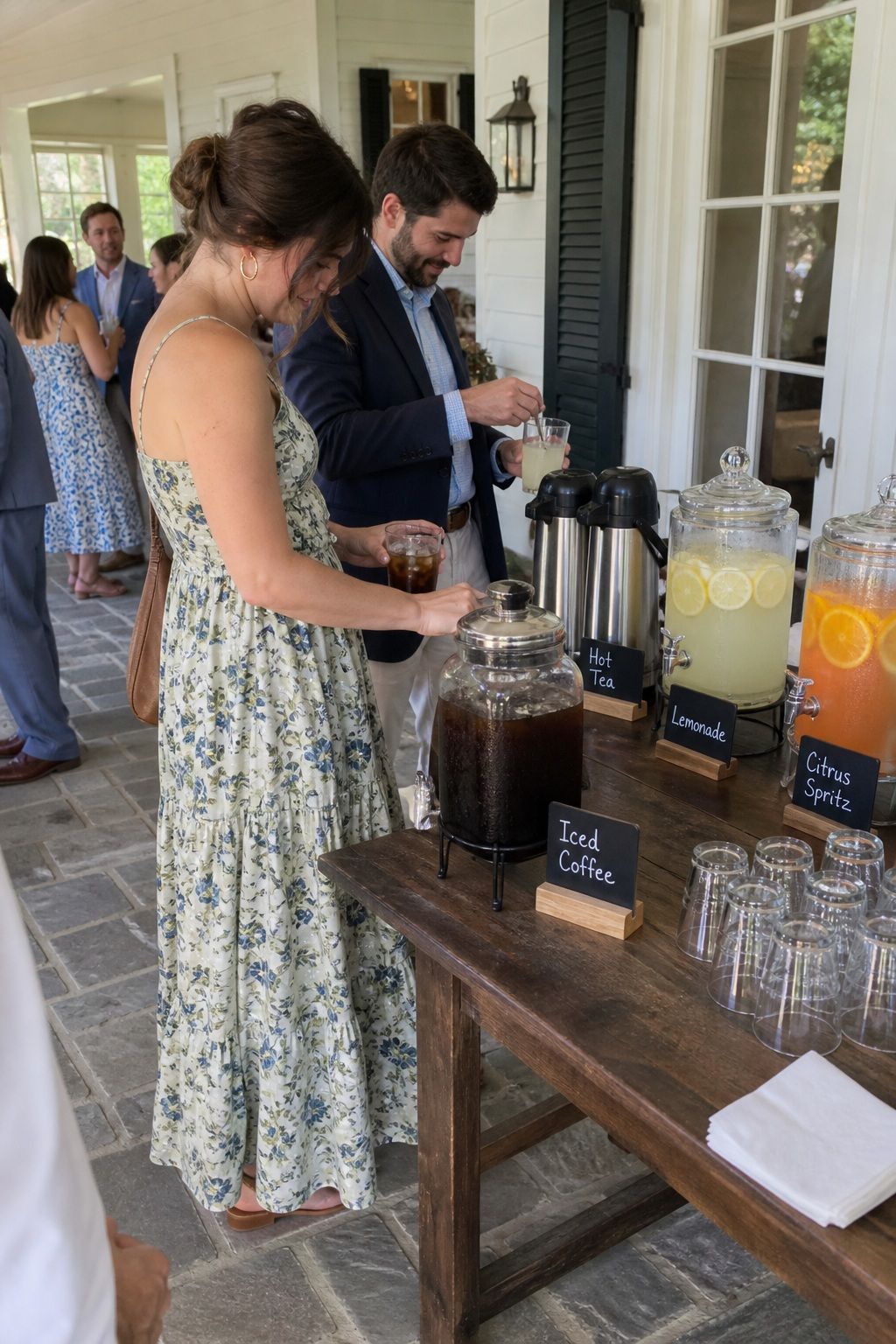 Guests serving iced coffee, tea, lemonade, and citrus spritz on a shaded veranda