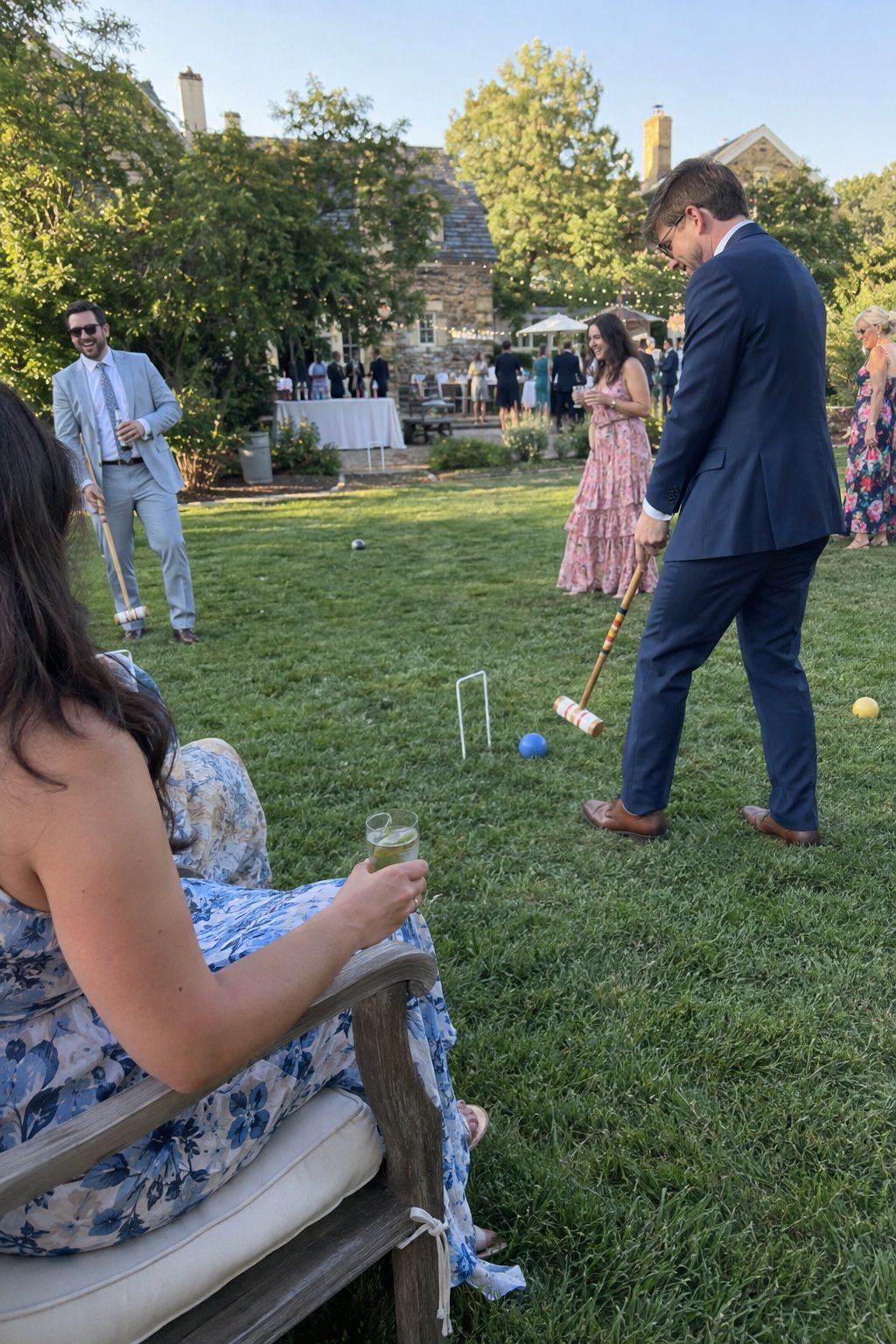 Wedding guests playing croquet in a separate garden cocktail-hour lawn