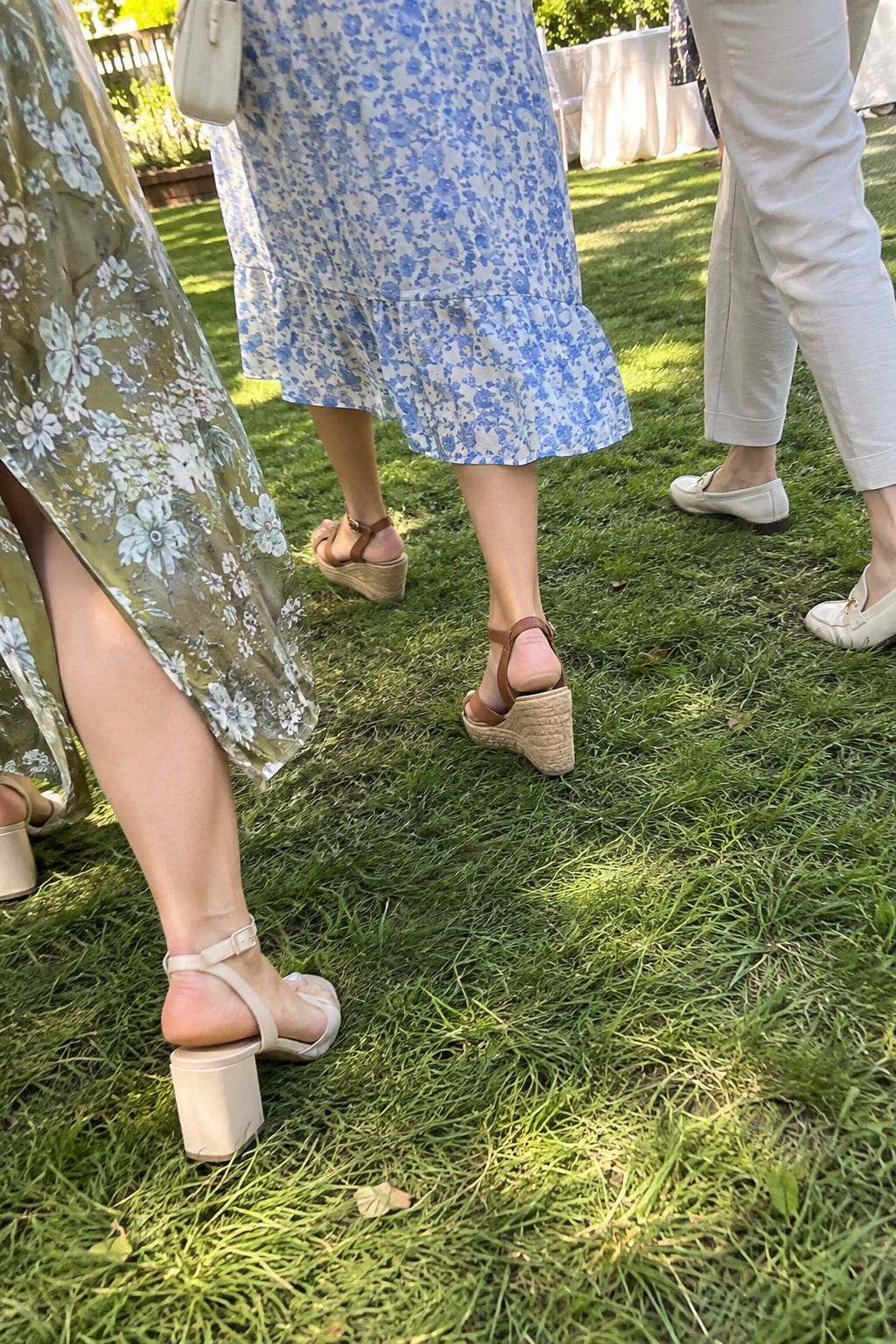 Guests walking on grass in broad block heels, wedges, and elegant flats