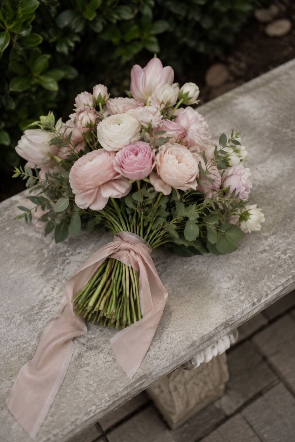 Blush hand-tied bouquet with sage foliage and trailing ribbon