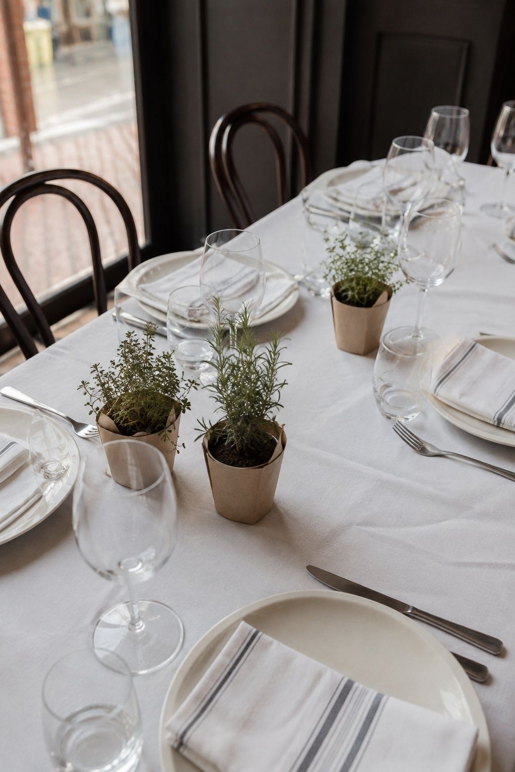 Potted herbs doubling as table greenery