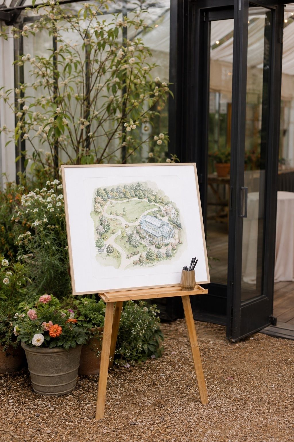 Illustrated garden map on an easel at a greenhouse entrance