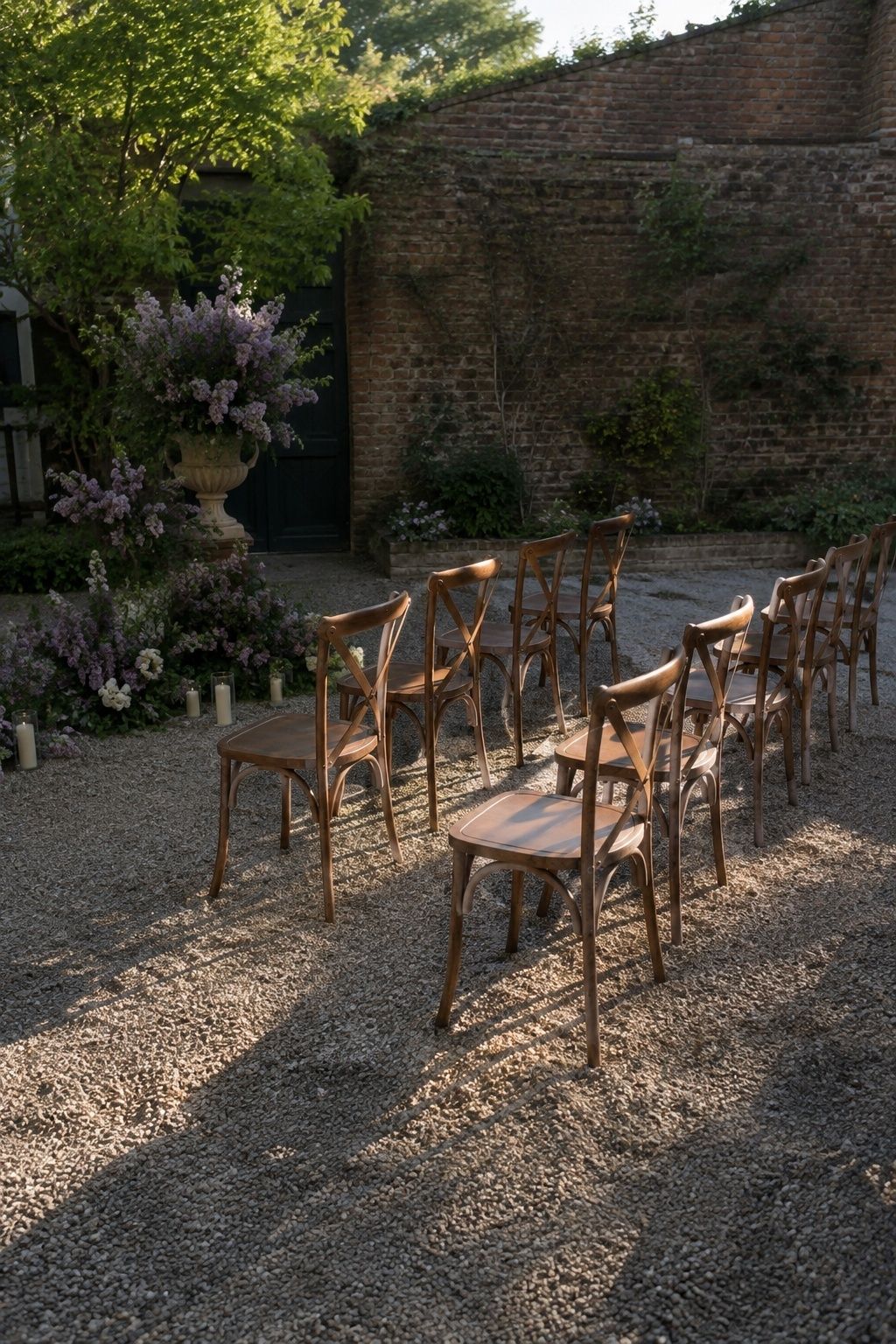 Wooden ceremony chairs and lilacs in soft late-afternoon light