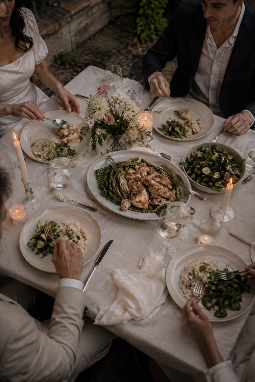 Shared roast chicken, spring vegetables and risotto at an intimate wedding dinner