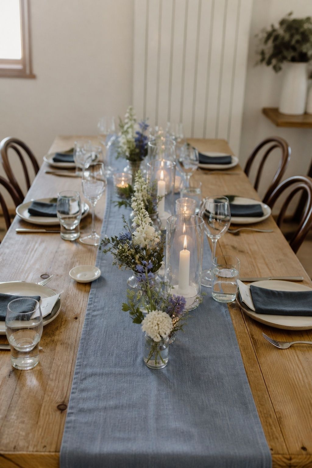 Dusty blue linen runner over a bare wood wedding table