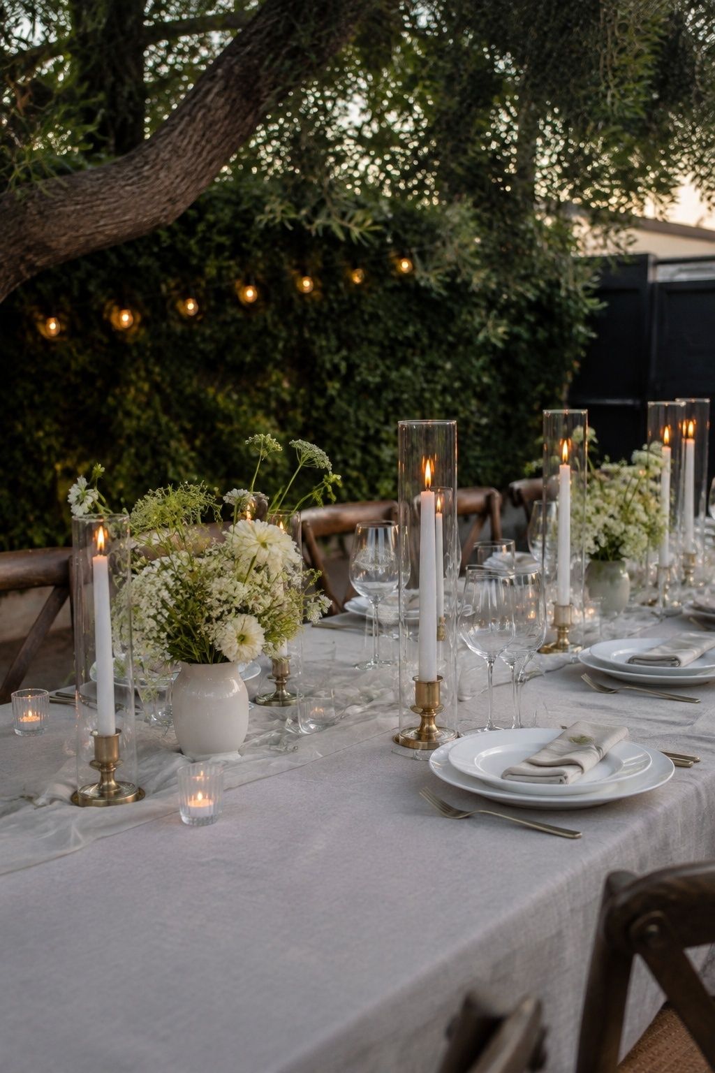Taper candles enclosed in tall clear glass sleeves