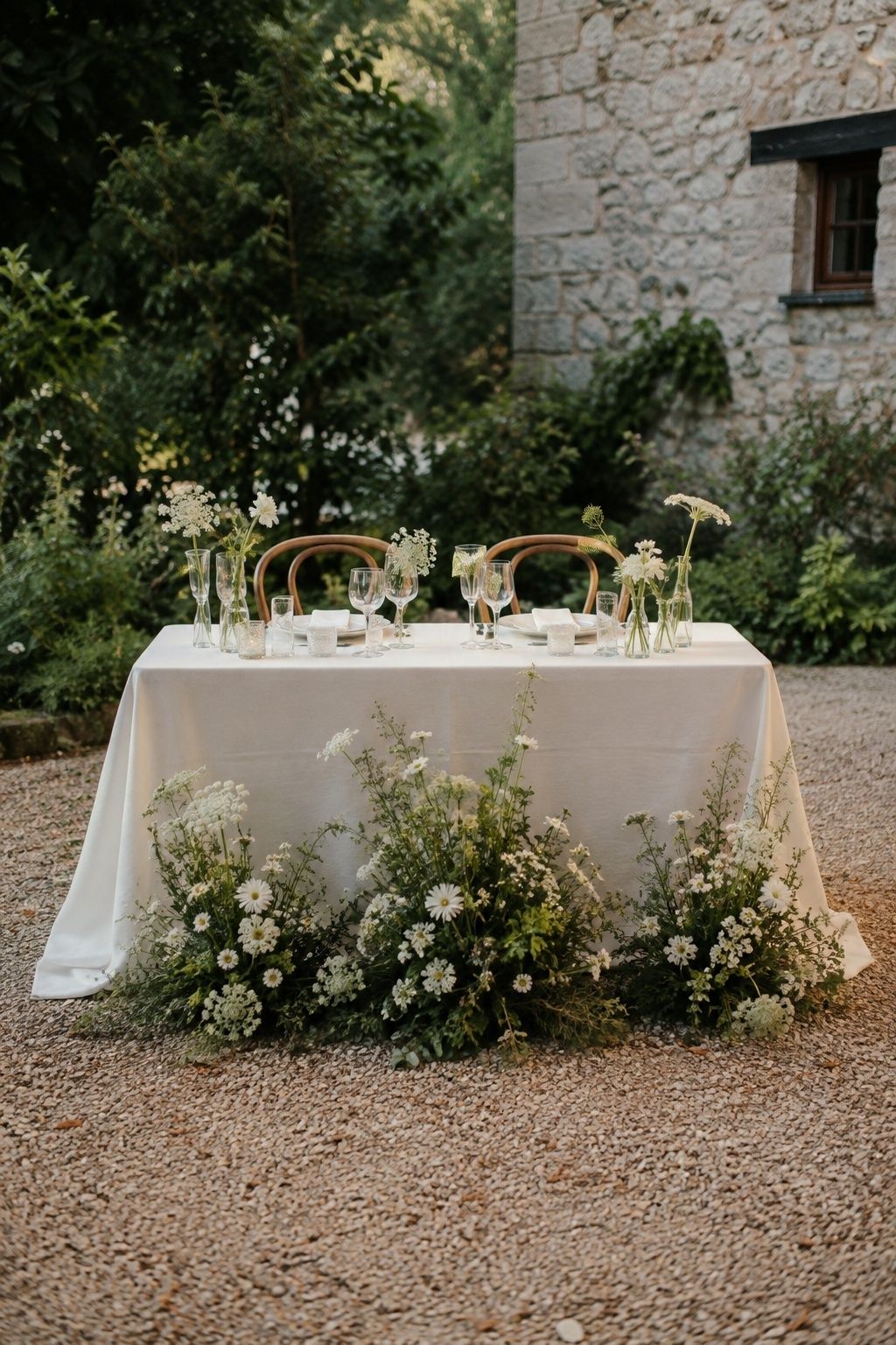 Meadow-style ceremony flowers repurposed around a sweetheart table