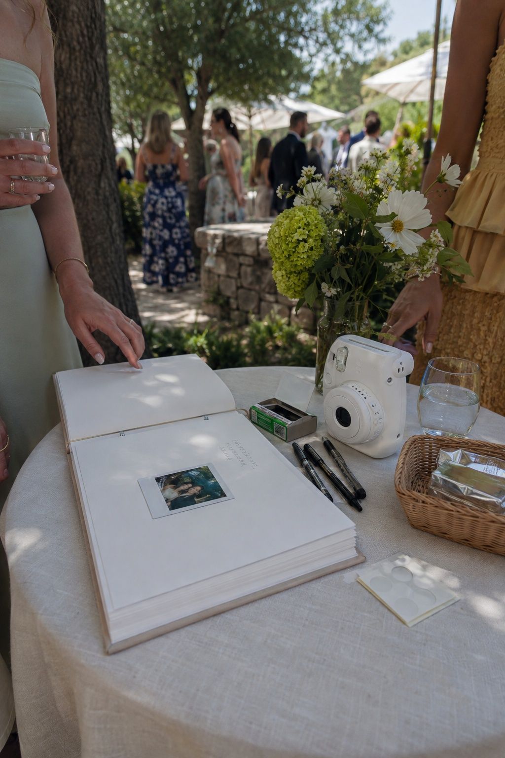 Polaroid guest book set in a shaded spot