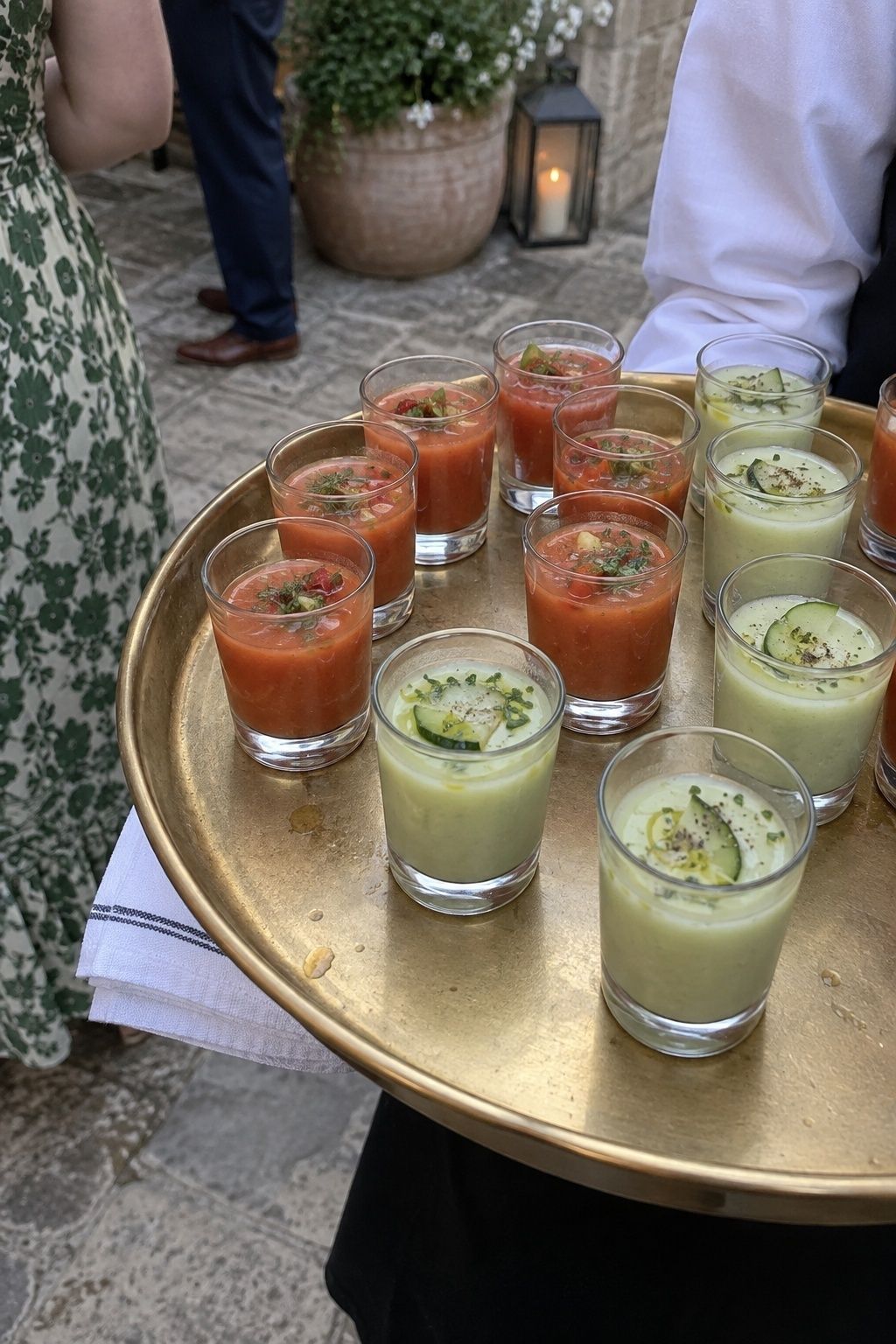 Tray of tomato gazpacho and cucumber soup shooters at a summer wedding