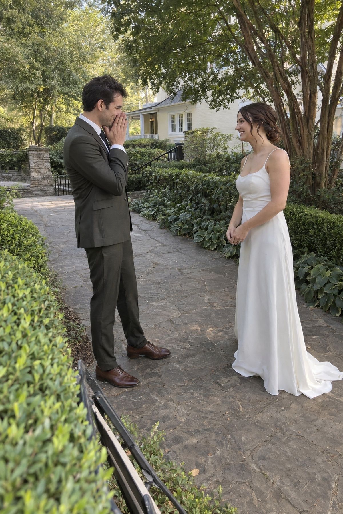 Newlyweds sharing a first look in a shaded garden before cocktail hour