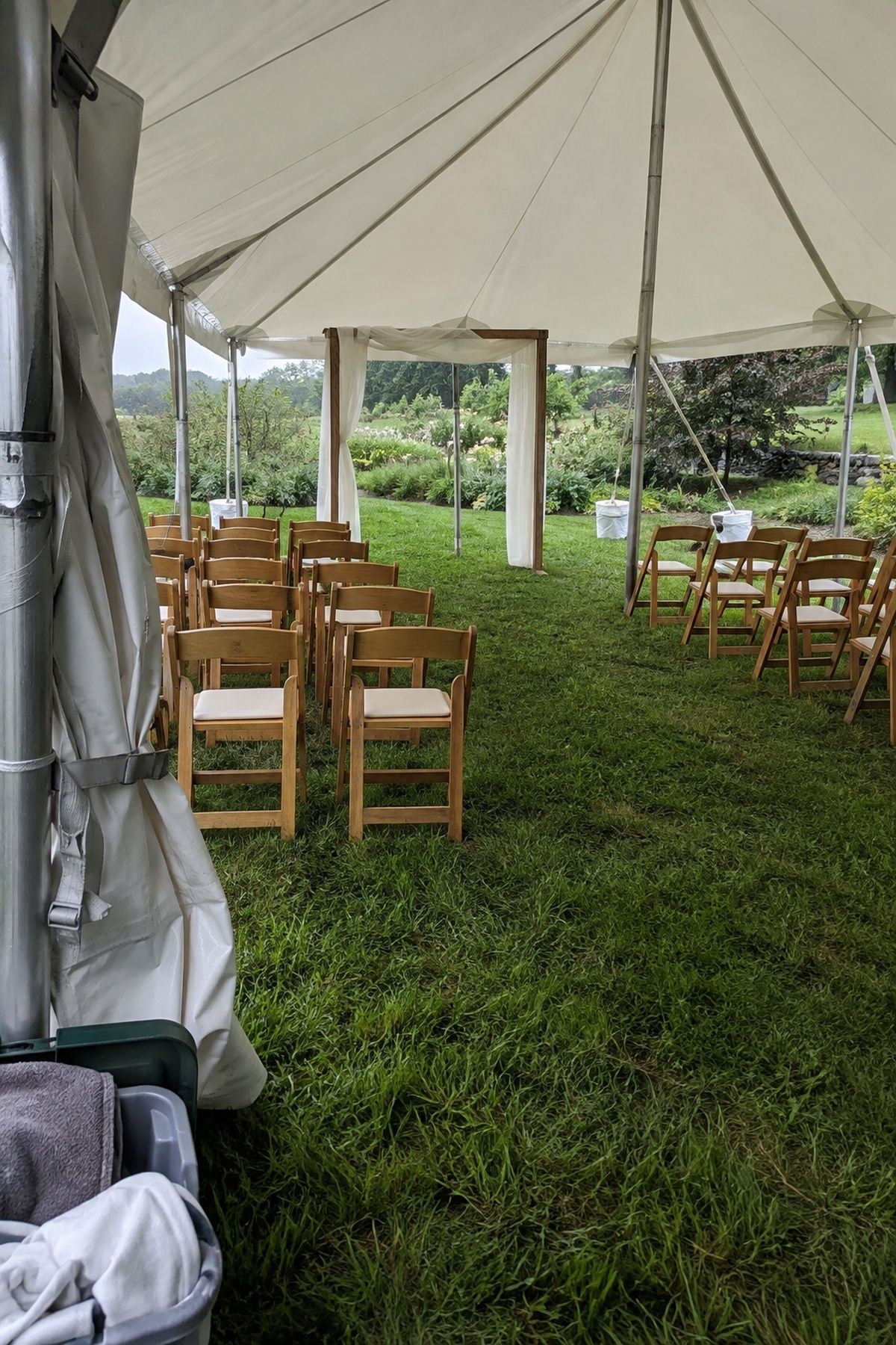 Open-sided tent ready as a small summer wedding weather backup