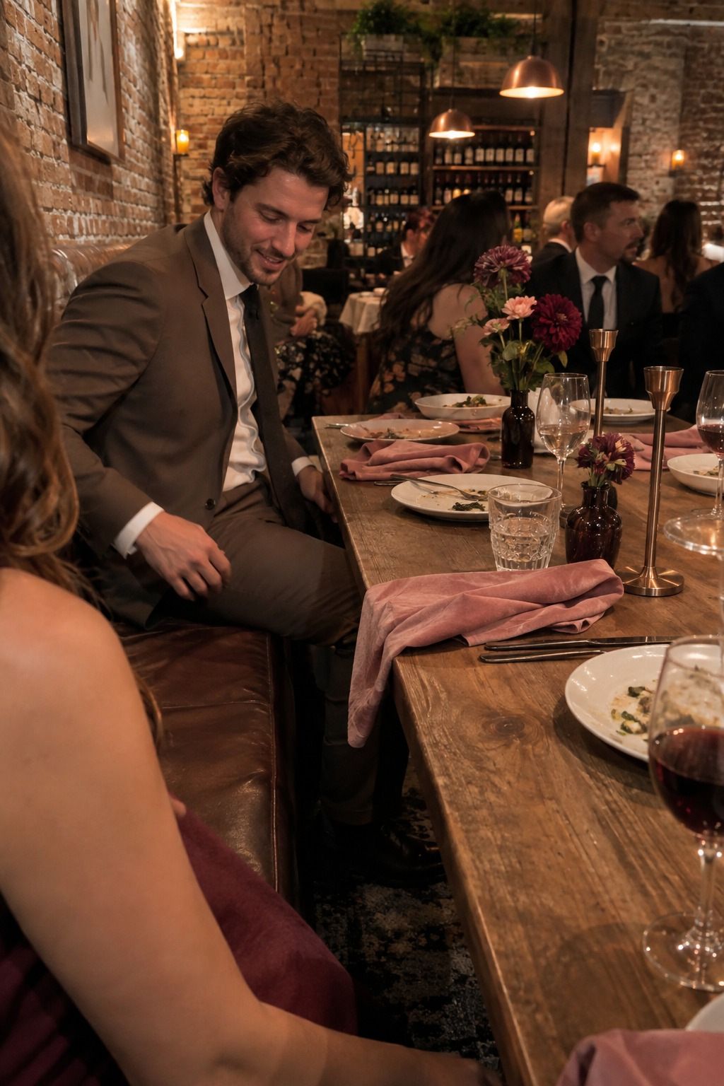 Wedding guest at a small wine-bar reception with berry flowers, dusty-rose linen, copper and mocha tones.