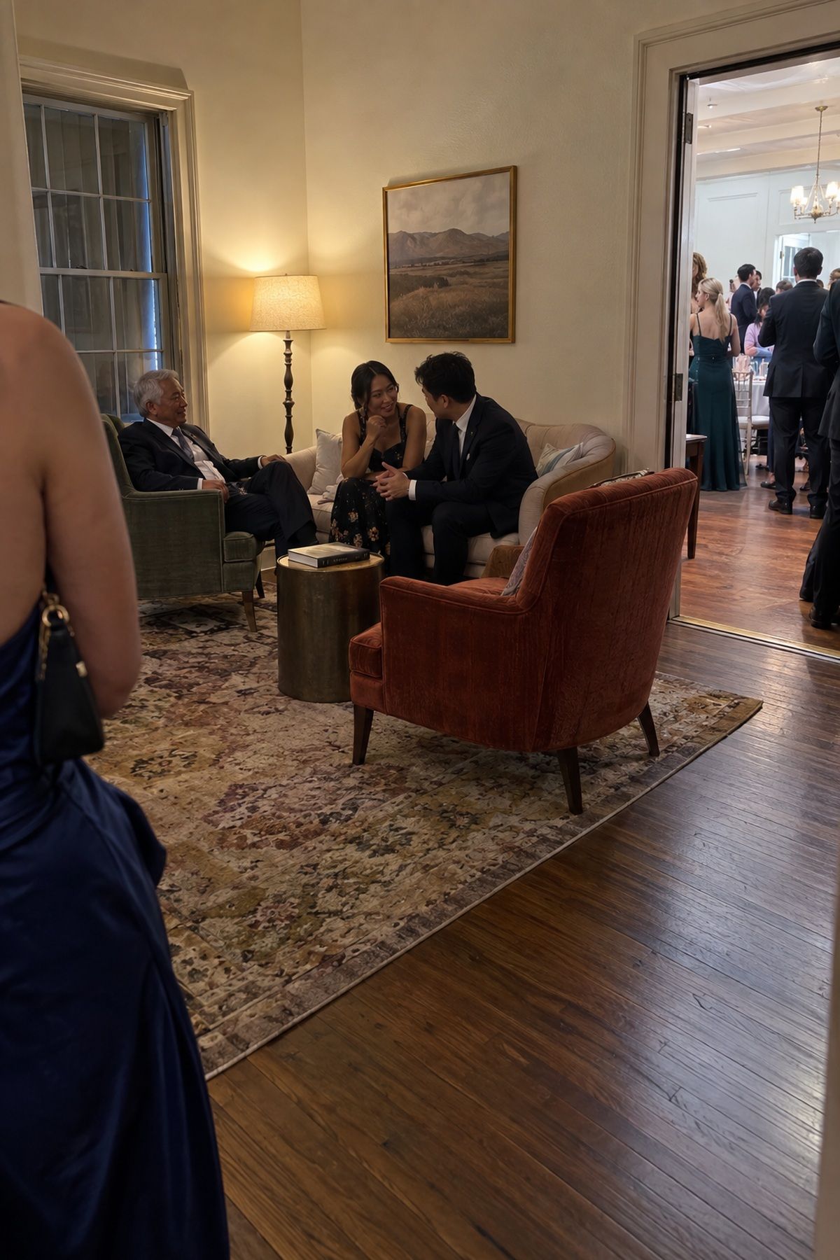 Guests rest and talk in a cozy lounge beside an intimate winter wedding reception.