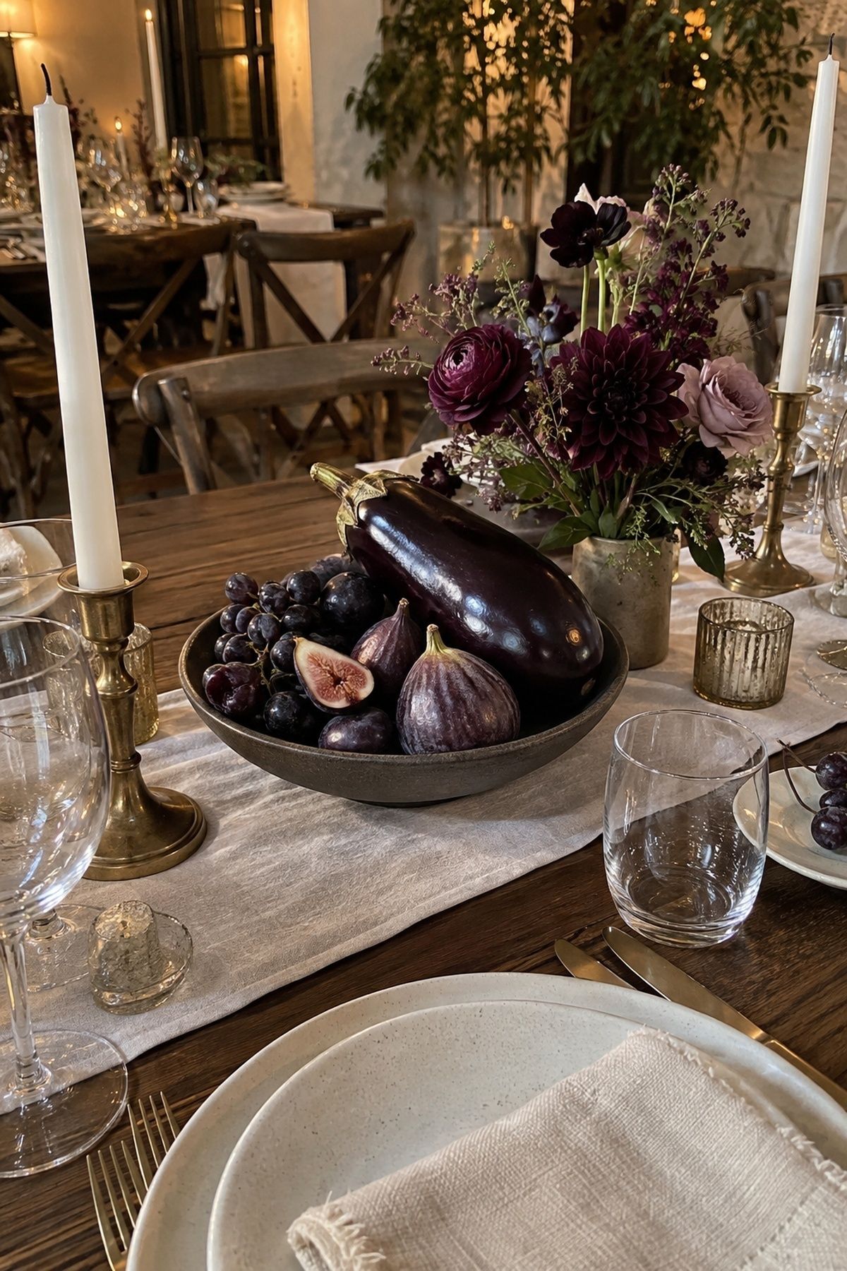 Eggplant and plum tones creating a moody wedding centerpiece palette