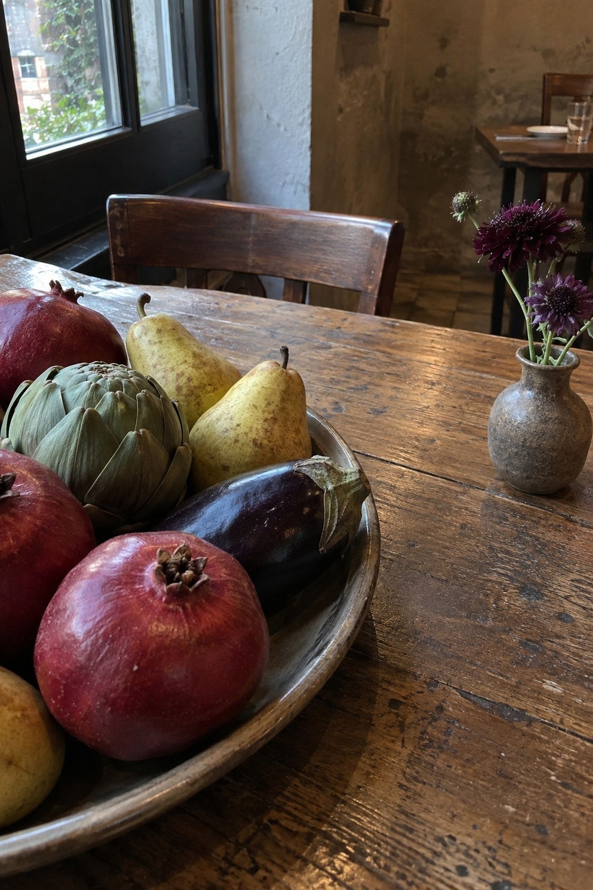Pomegranate artichoke pear and eggplant wedding still life with separate plum flowers